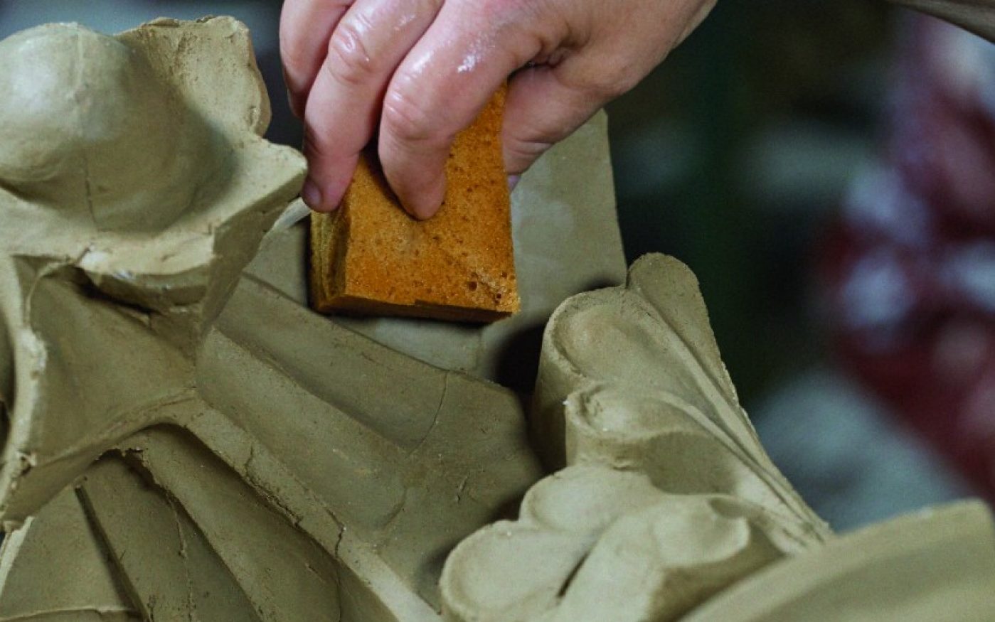 Worker in the manufactory buchwaeldchen shaping a special brick