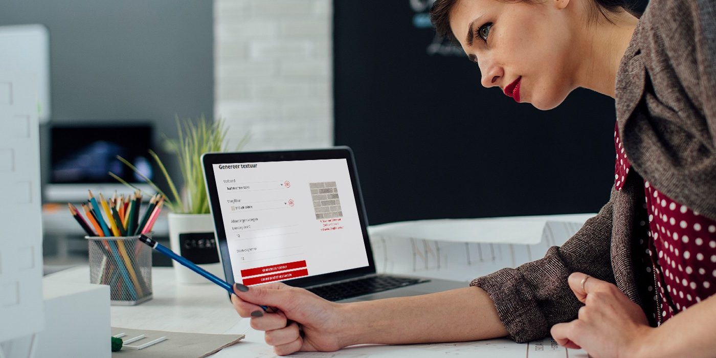 Female architect working in her new modern office. Standing and examining blueprints for her new project. There are on the desk in front of her laptop, architectural model on new business building and color swatch.