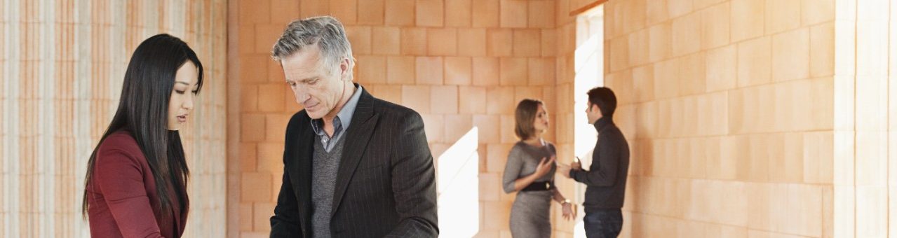 Planners inspecting building materials in unfinished building