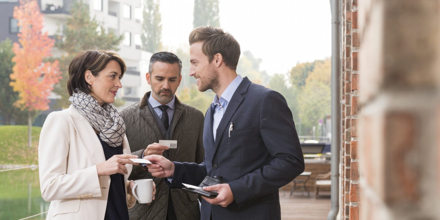 Business people talking and exchanging business cards