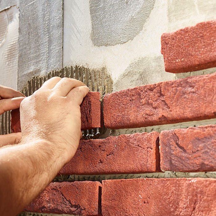 Installing brick slips on insulation panels