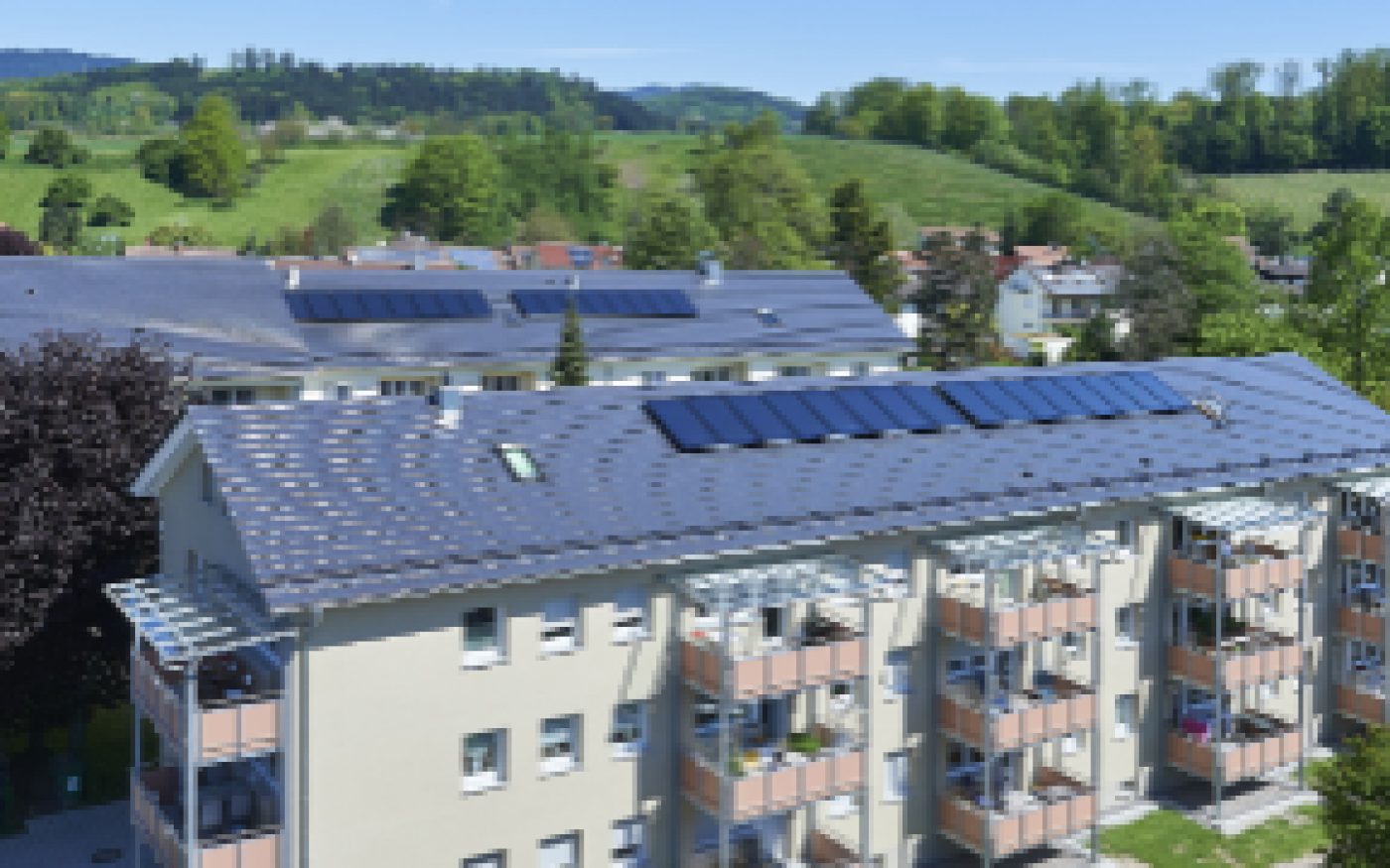 Multi-family house, bird's eye view, roof, solar system, balcony, meadow