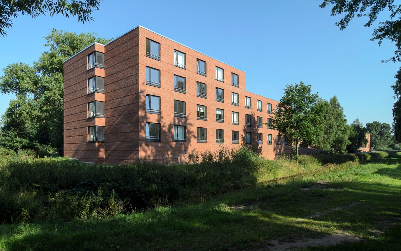 Remote view of a dormitory, large lawn and bushes, trees, Campus 460