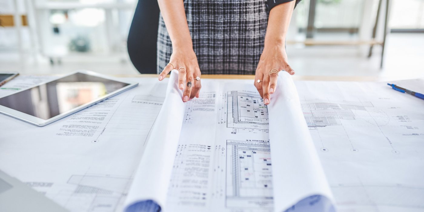 Closeup shot of an unrecognisable businesswoman working with blueprints in an office