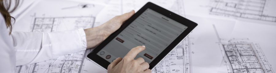 Woman at workplace with blueprint holding tablet computer, Fast Forward Commercial Excellence