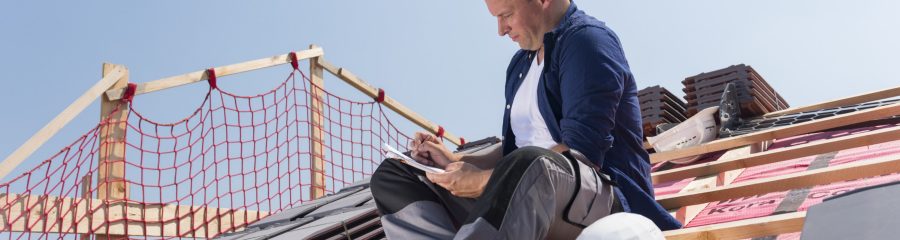 Roofer sitting on timber batten