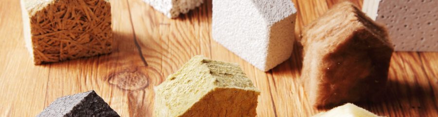 Close up Various Scattered Blocks of insulation Model Hous in Different Standing on Top of the Wooden Table