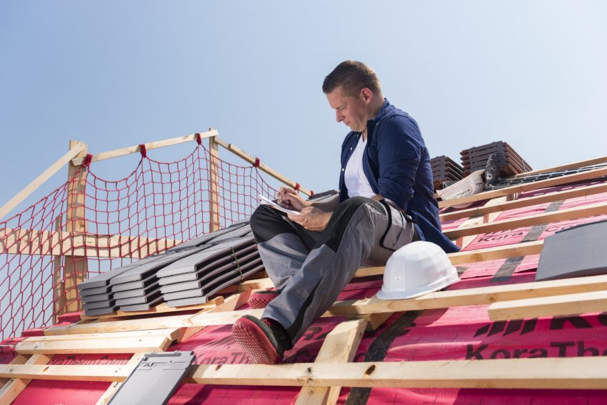 Roofer sitting on timber batten