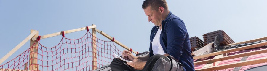 Roofer sitting on timber batten