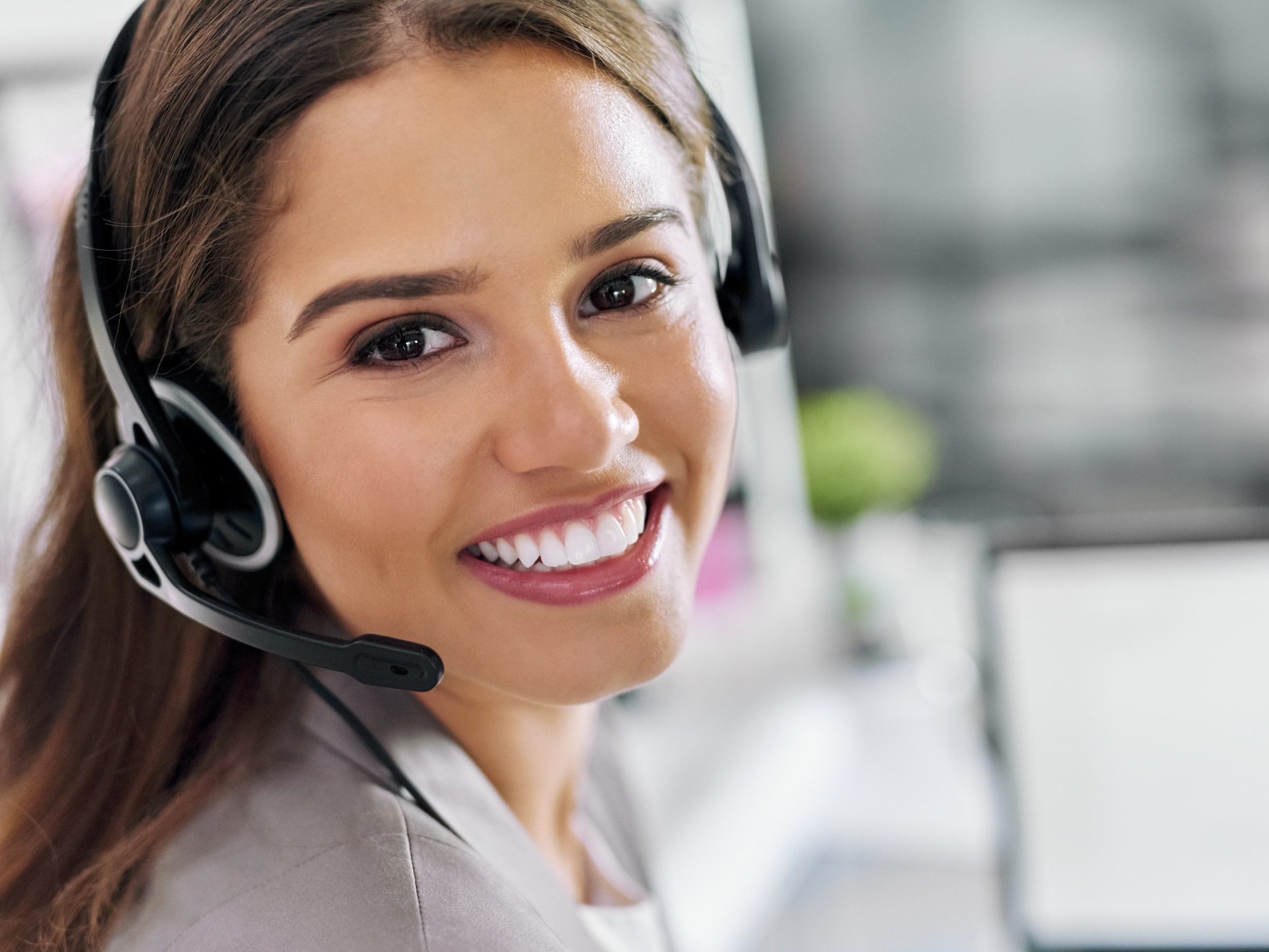 Portrait of a young call centre agent working in an office