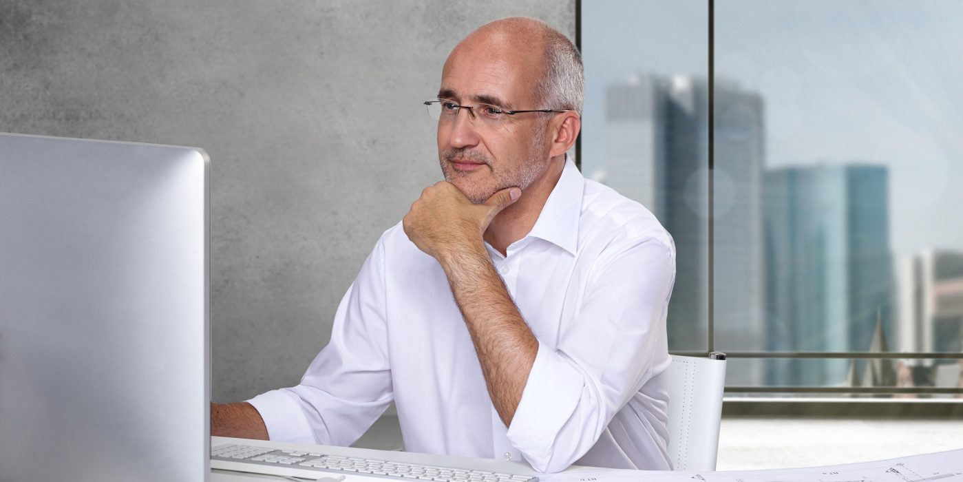 architect man sitting at table computer
