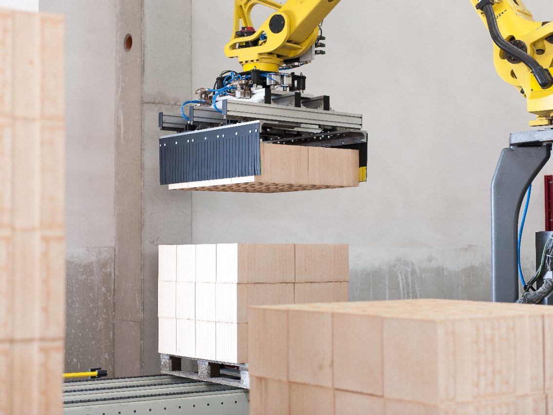 Robot lifting blocks at production plant Haiding